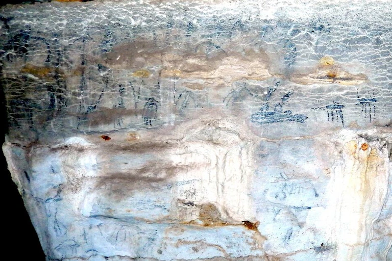 A rock surface bearing faint images.