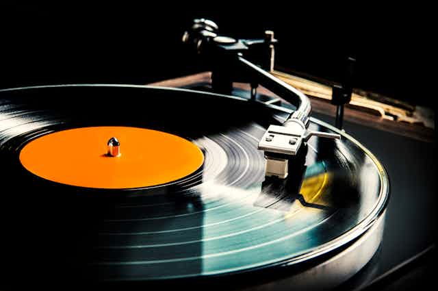 A vinyl record being played on a record player.