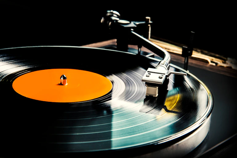 A vinyl record being played on a record player.