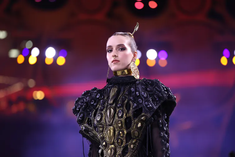 Model in black on catwalk