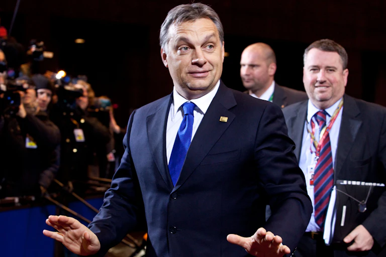 Viktor Orbán wearing a blue suit in front of a crowd.