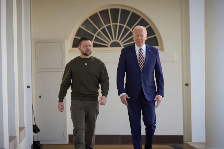 Presidents Zelensky and Biden walk outside the White House.