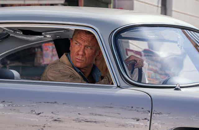 James Bond (Daniel Craig) behind the wheel of an Aston Martin in 'Death Can Wait'.