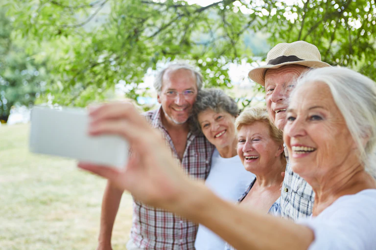Group of elderly people taking a selfie with a smart phone