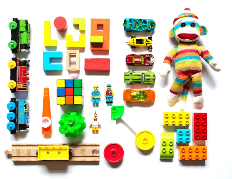 A colourful selection of children's toys on a white background.