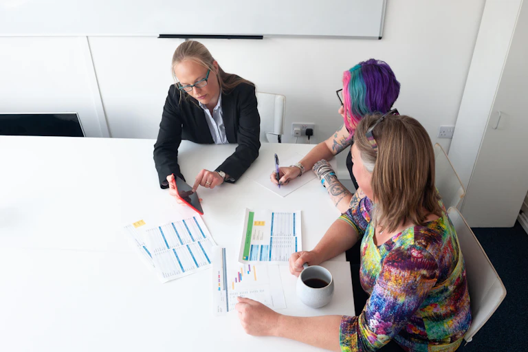 Two women being trained by a businesswoman