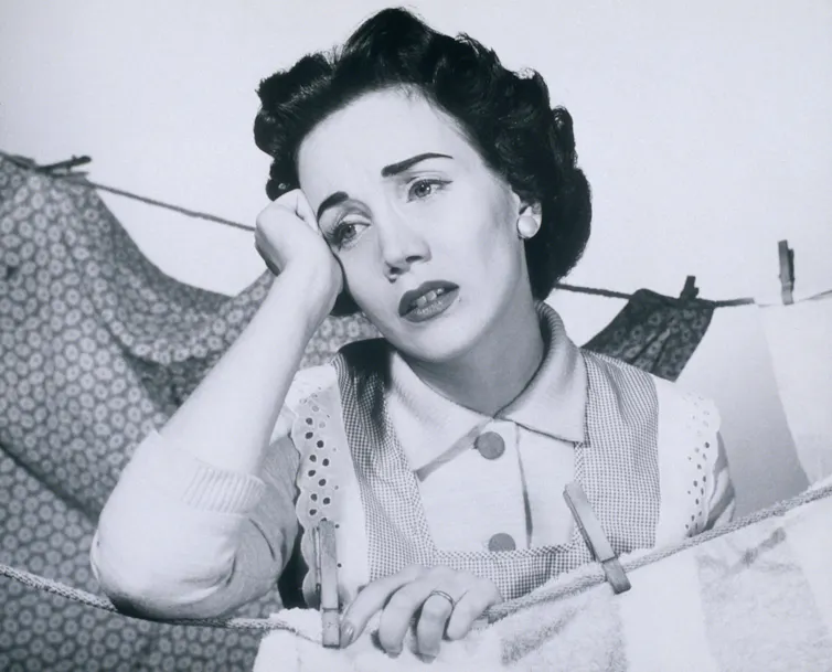 bored 1950s woman hanging out washing