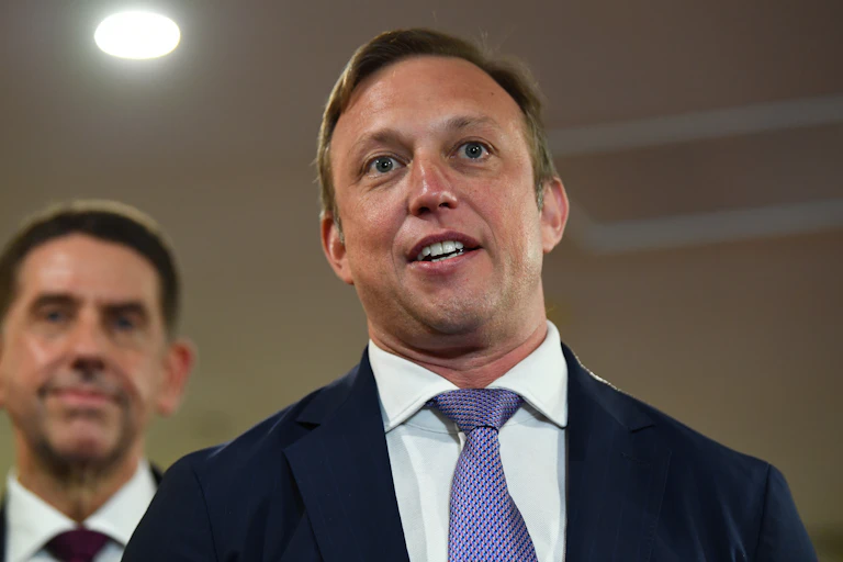 photo of man in suit looking at camera