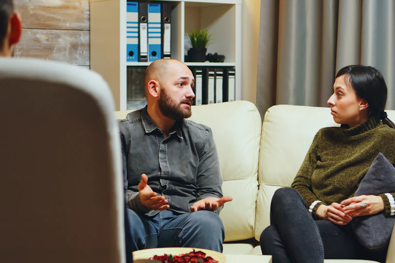 Man talks to woman in therapy