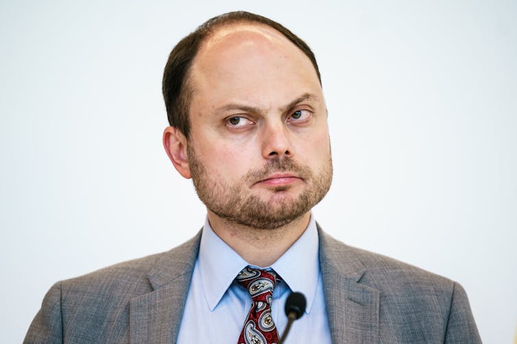 Head and shoulders shots of Russian opposition politician Vladimir Kara-Murza wearing a suit and tie.