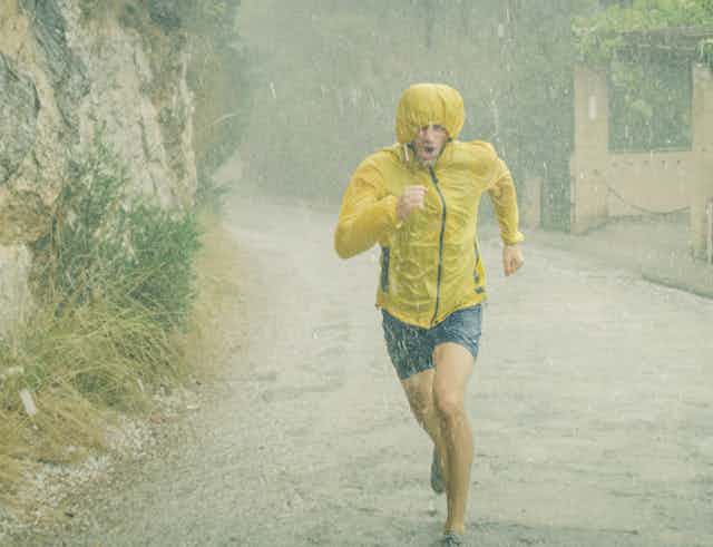 man running for exercise in pouring rain
