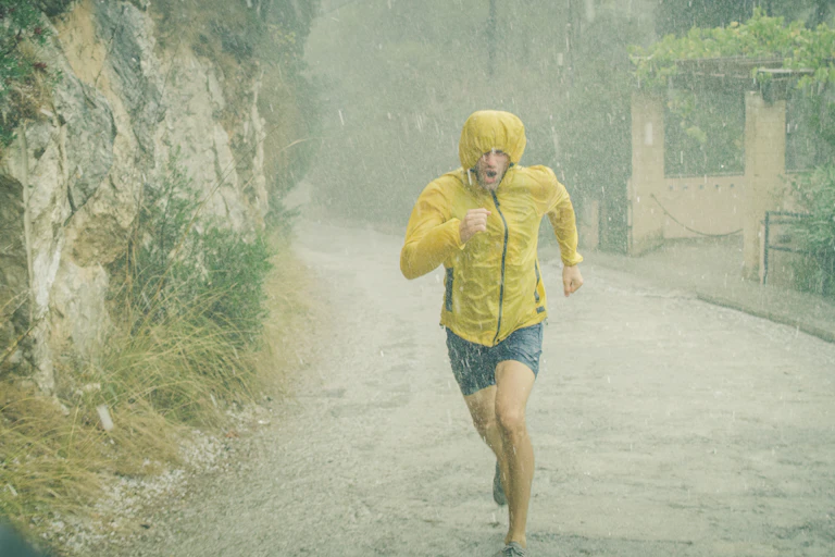 man running for exercise in pouring rain