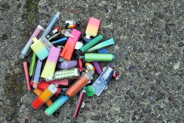 Collection of disposable vapes on the ground