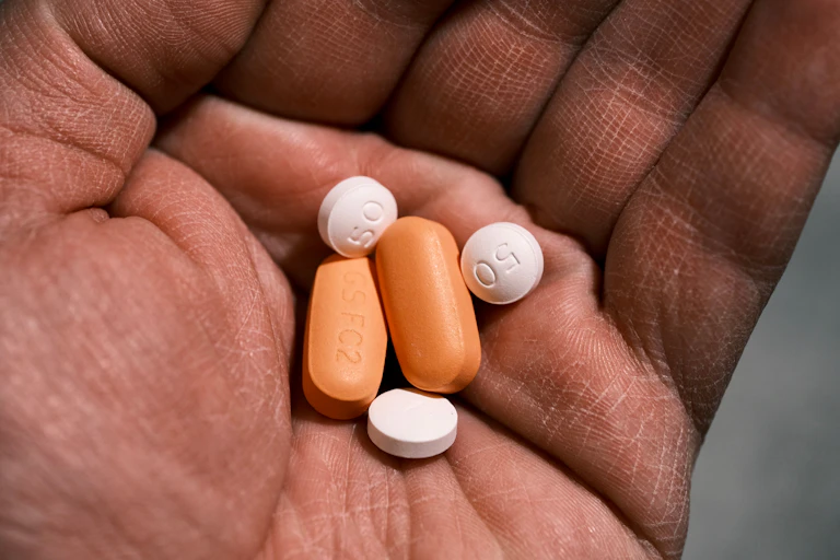 Hand holding antiretroviral drugs