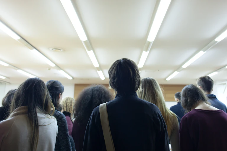 Young people facing away from camera