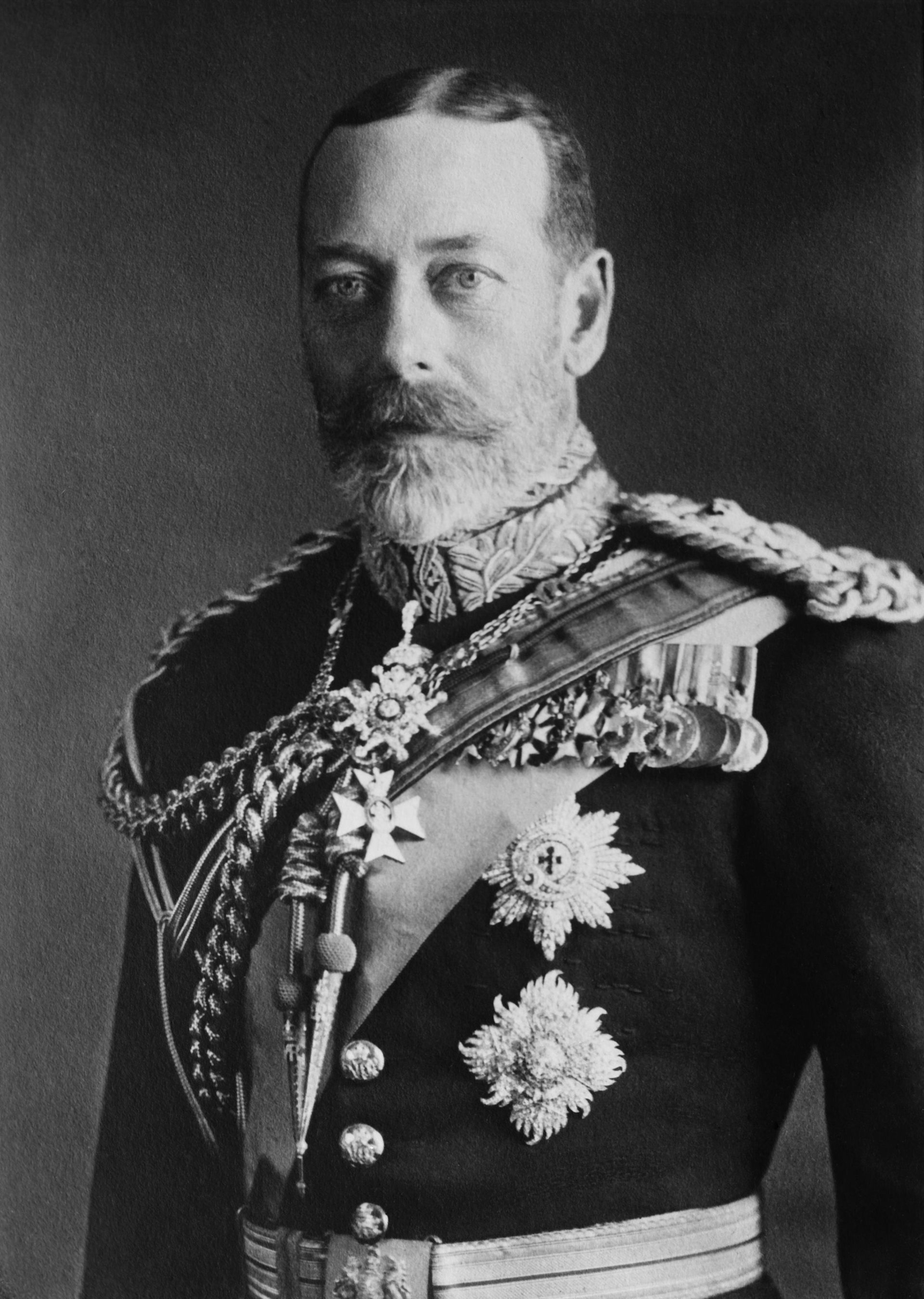 A black and white photograph of King George V in full dress uniform.
