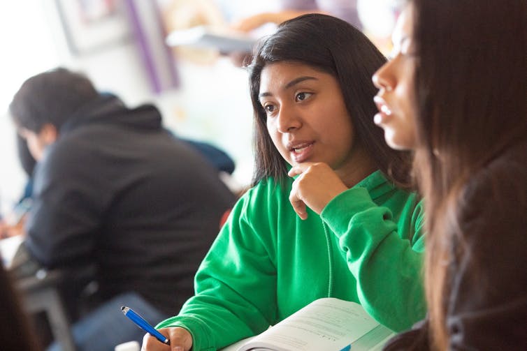 A brown girl teen seen in discussion.