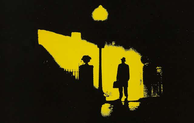 Movie poster featuring silhouette of man walking at night.
