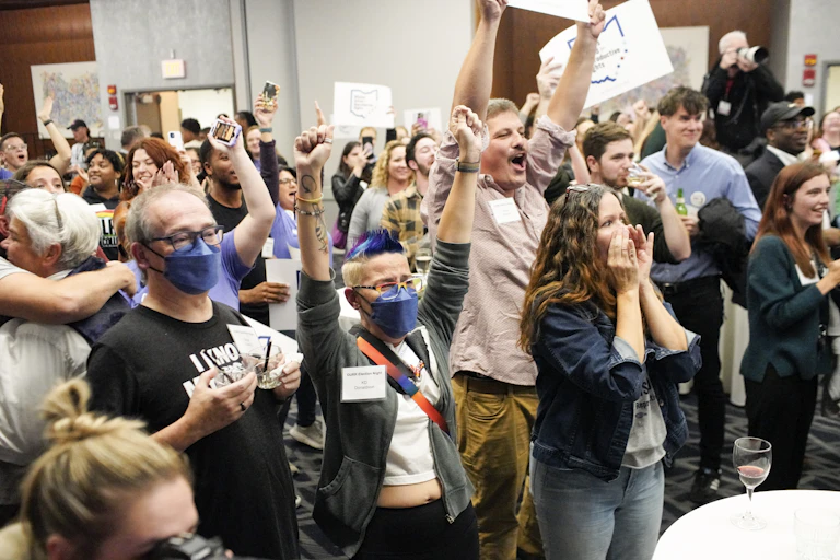 A crowd of people, cheering.