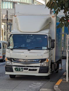 Mitsubishi Fuso eCanter electric light duty truck driving down a city street