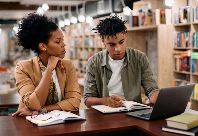 Black man and woman studying in library