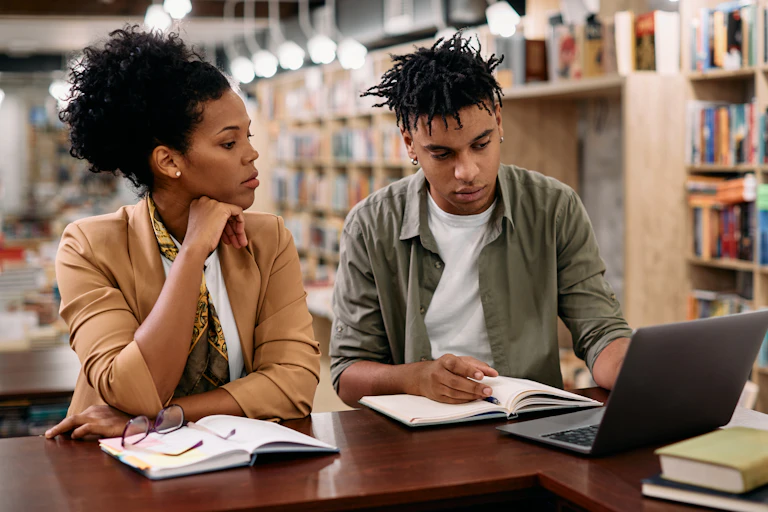 Black man and woman studying in library