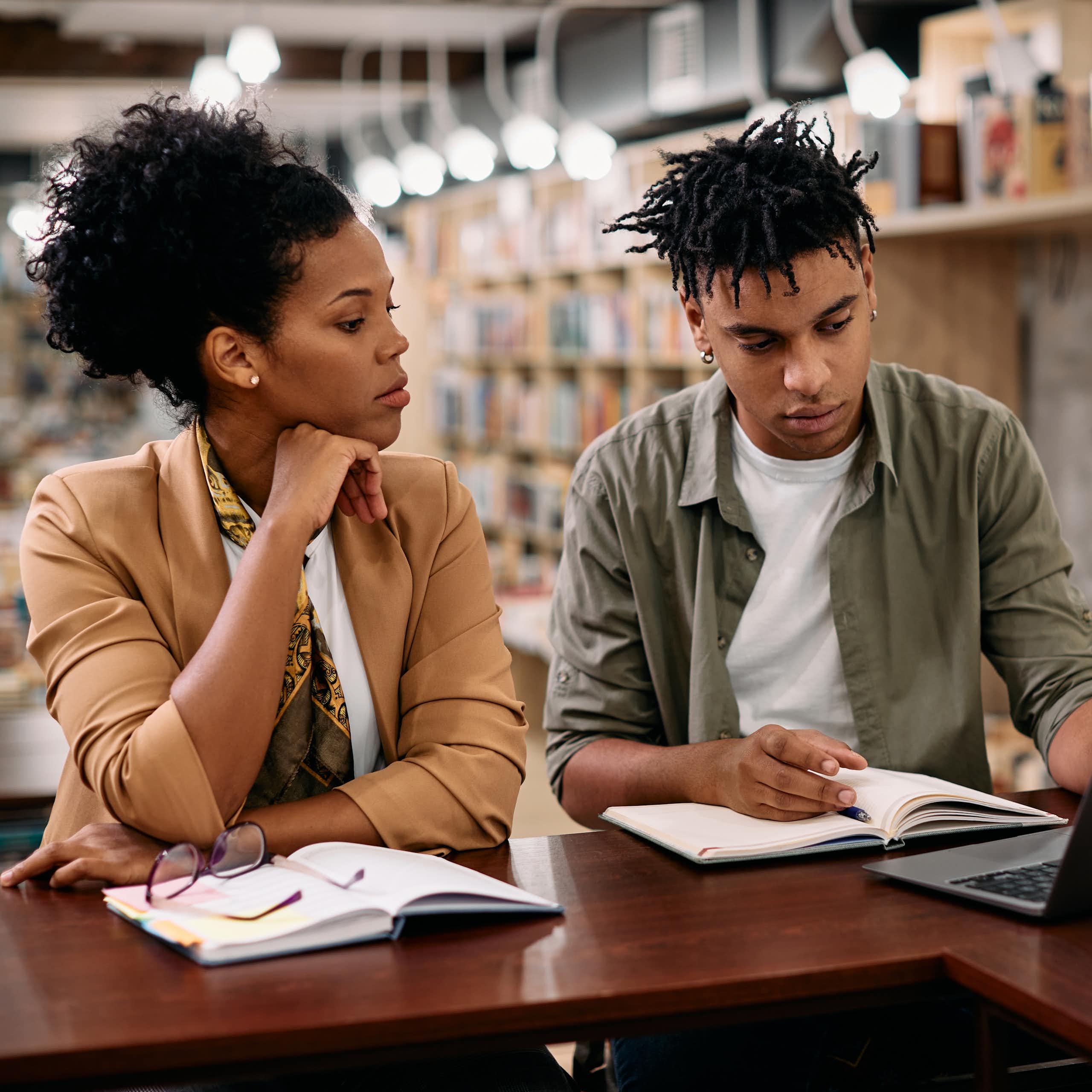 Black man and woman studying in library