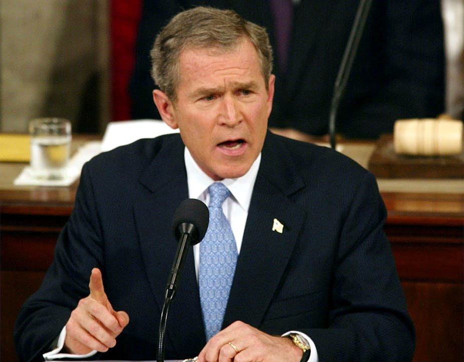 Former president George W Bush at a microphone.