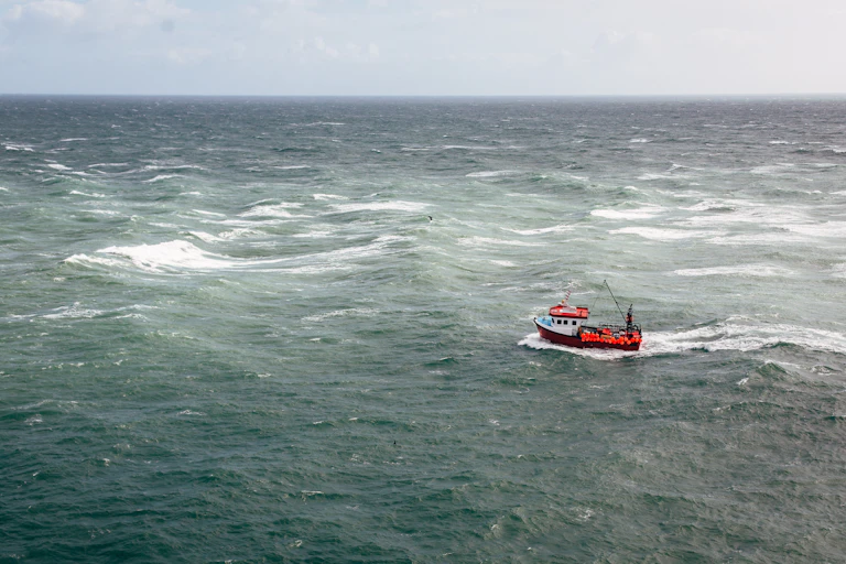 A small fishing trawler on the open ocean