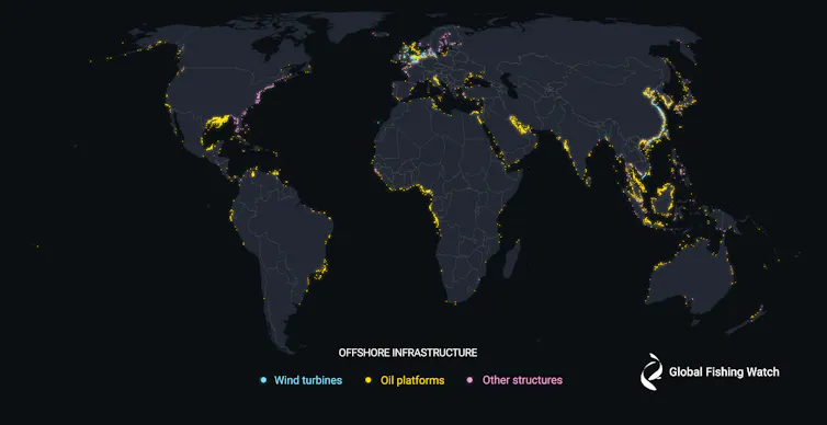 World map with locations of wind turbines, oil and gas platforms and other structures highlighted along coastlines.