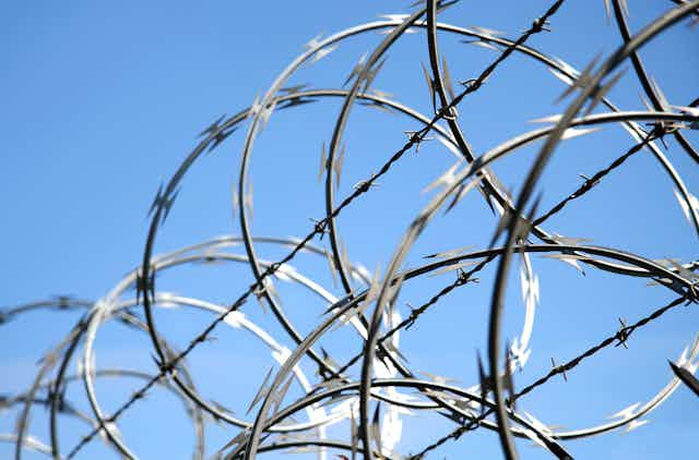 Close up photo of razor wire on a fence
