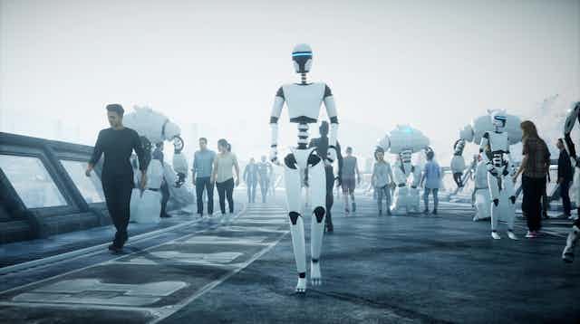 people and humanoid robots walk along a futuristic street