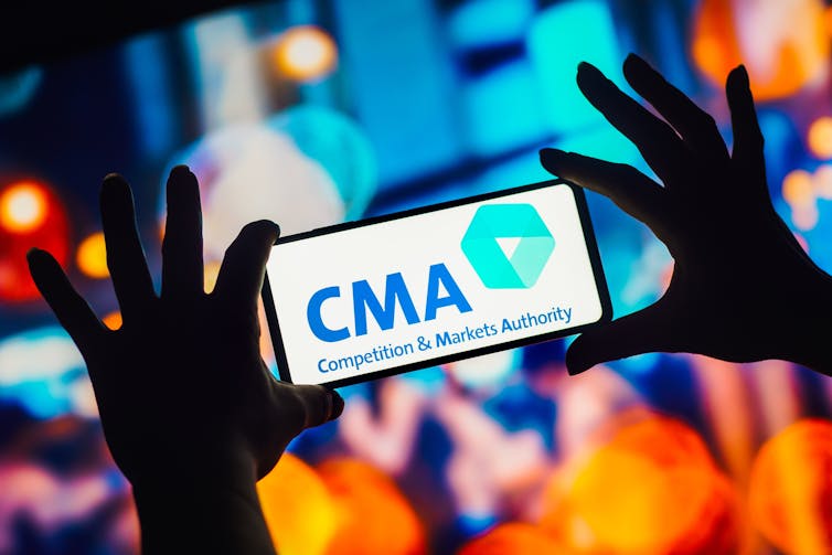 Two hands holding a smartphone with the CMA logo, brightly coloured background.