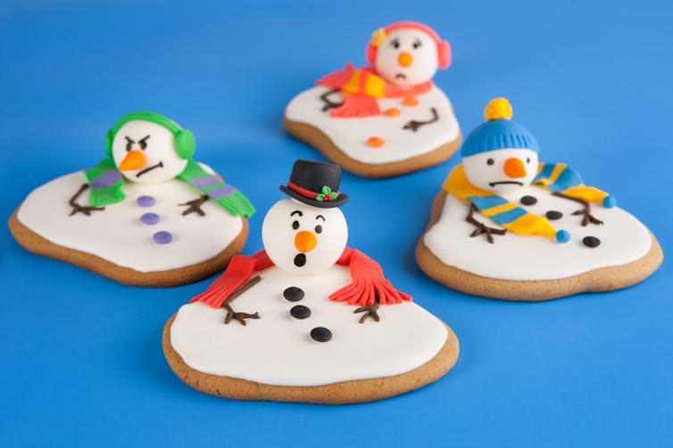 Melted snowman cookies on a blue background