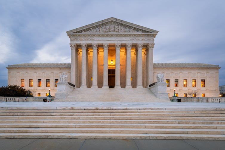 A large, impressive building with columns atop wide granite stairs.