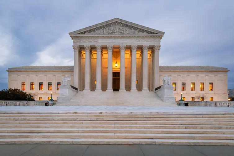 A large, impressive building with columns atop wide granite stairs.