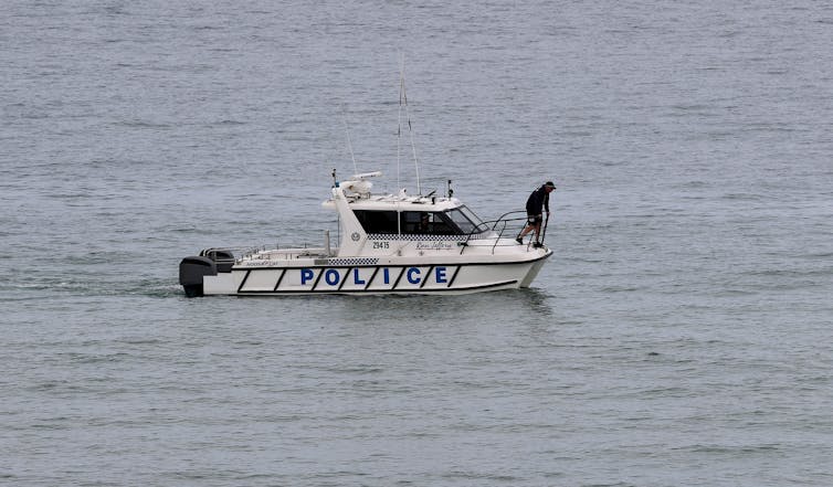 police on boat search ocean