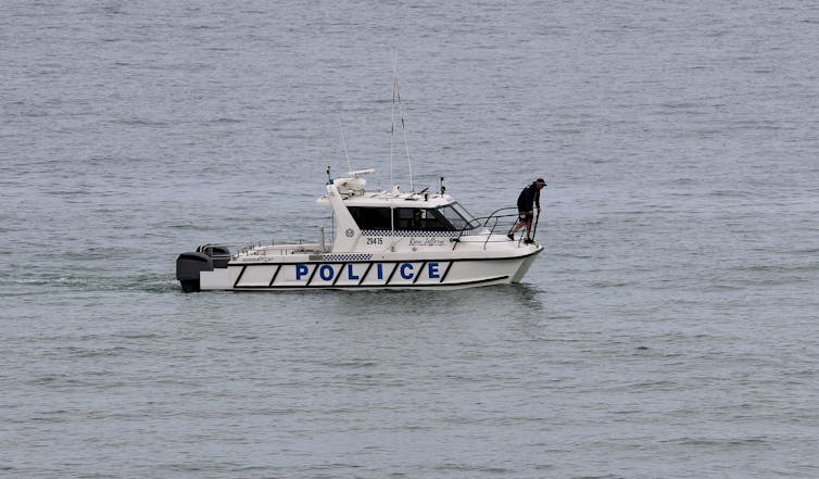 police on boat search ocean