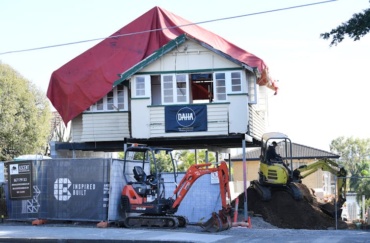 An old weatherboard house raised off the ground for renovations