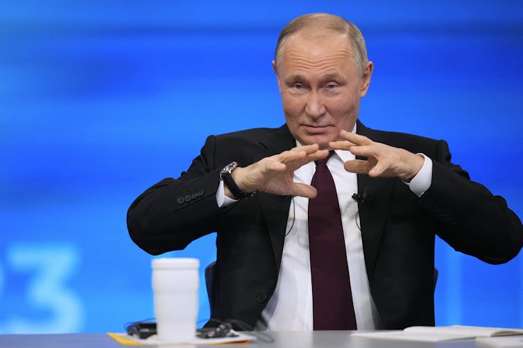 Russian president, Vladimir Putin, gestures with his hands during his annual press conference.
