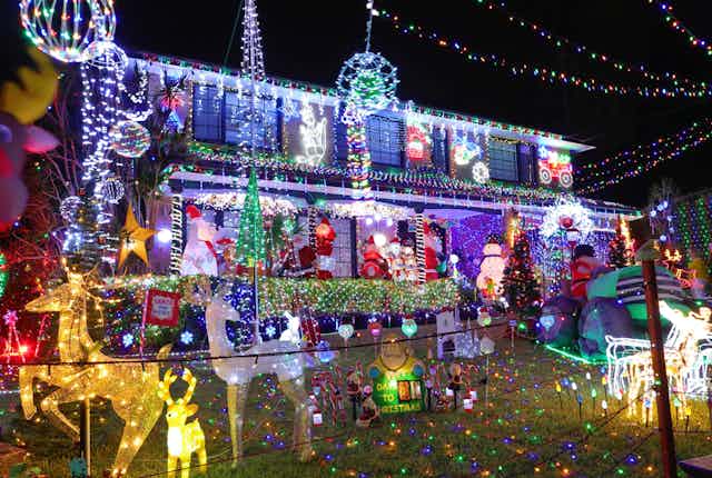 House covered in Christmas lights and decorations.