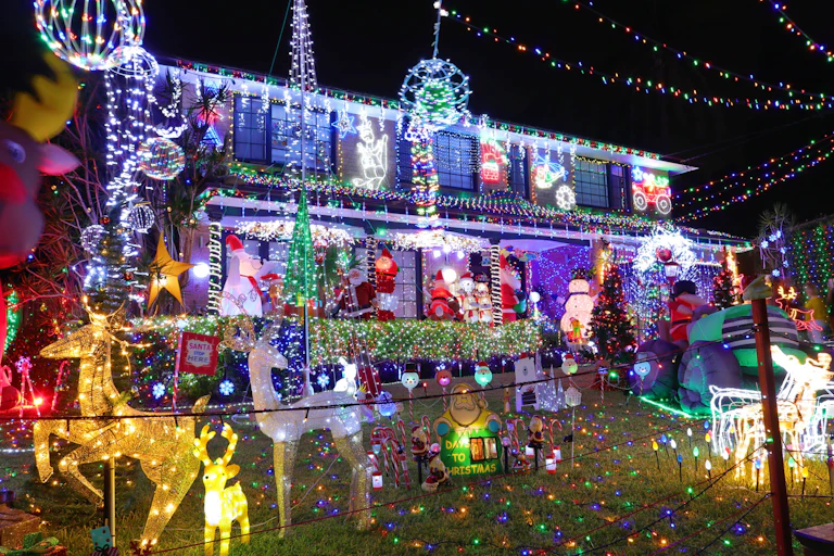 House covered in Christmas lights and decorations.