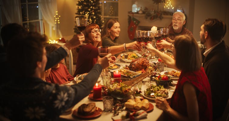 A toast being raised over the Christmas meal.