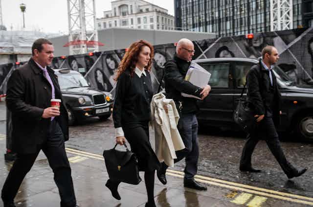 Rebekah Brooks and her entourage walking in a London street. 