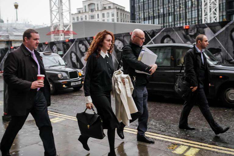 Rebekah Brooks and her entourage walking in a London street.