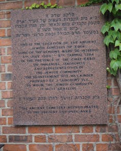 A commemorative plaque on a brick wall.