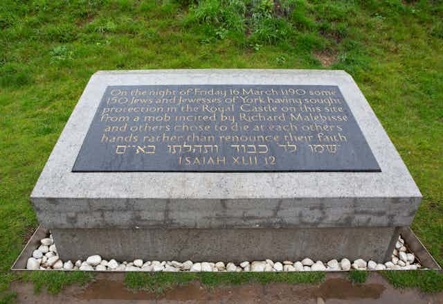 A plaque on a stone memorial.