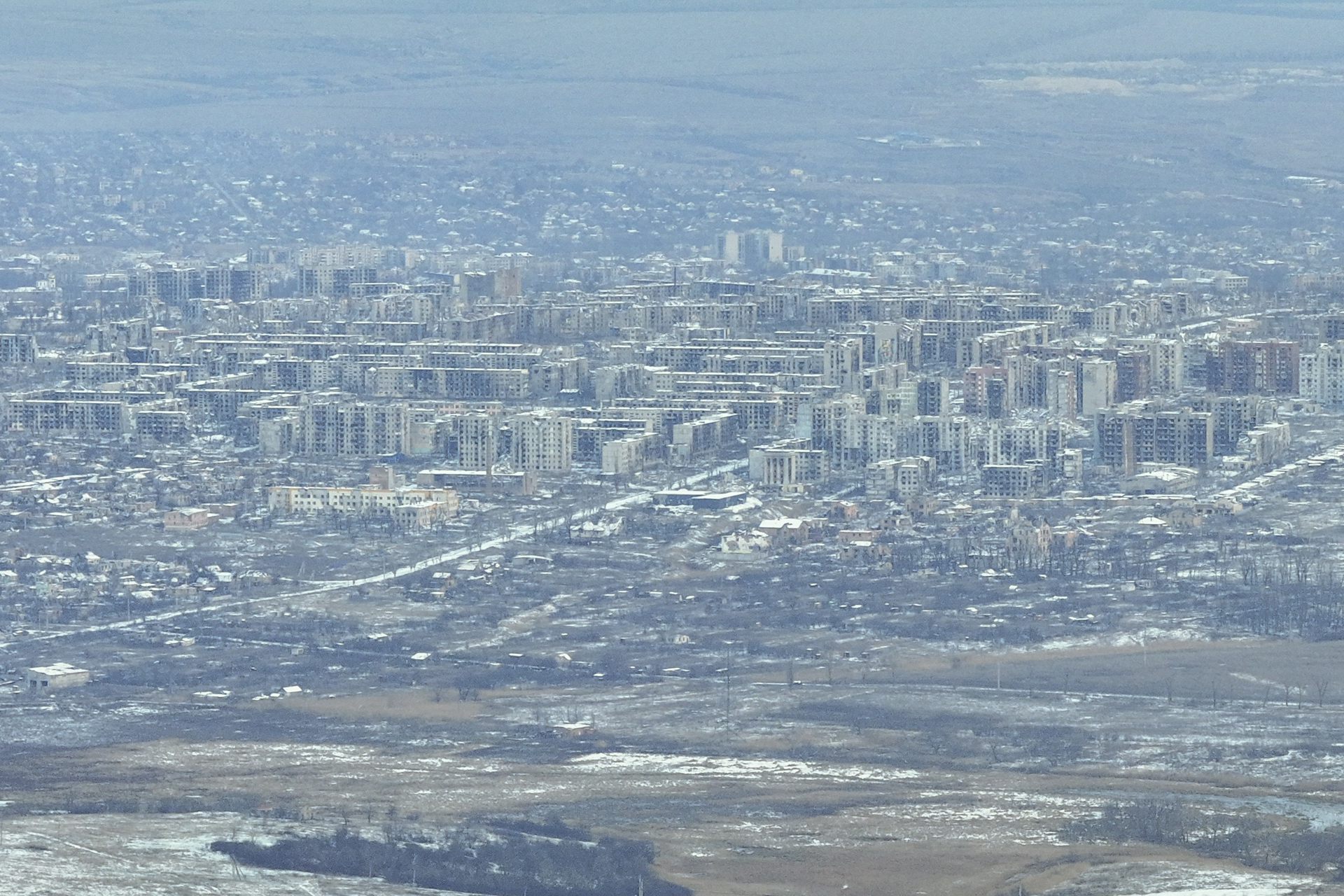 An aerial photo of a city with heavily damaged buildings.