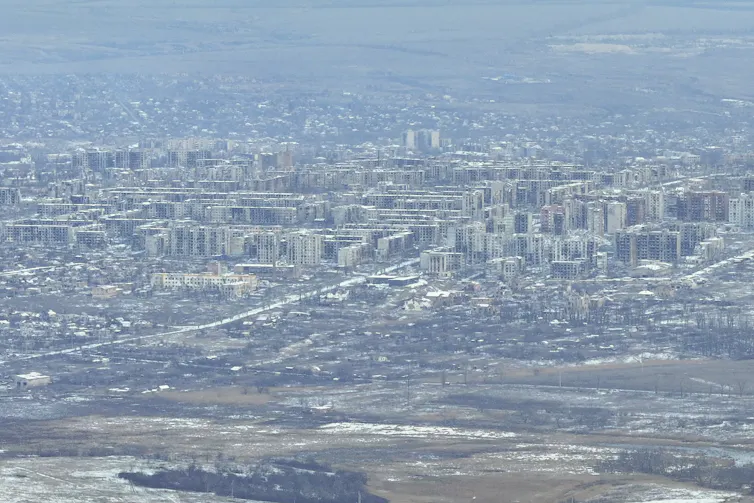An aerial photo of a city with heavily damaged buildings.