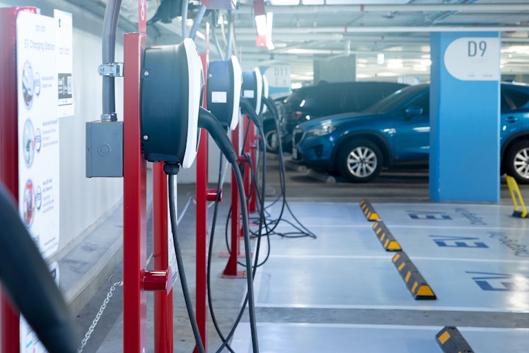 A parking lot with cars and charging stations